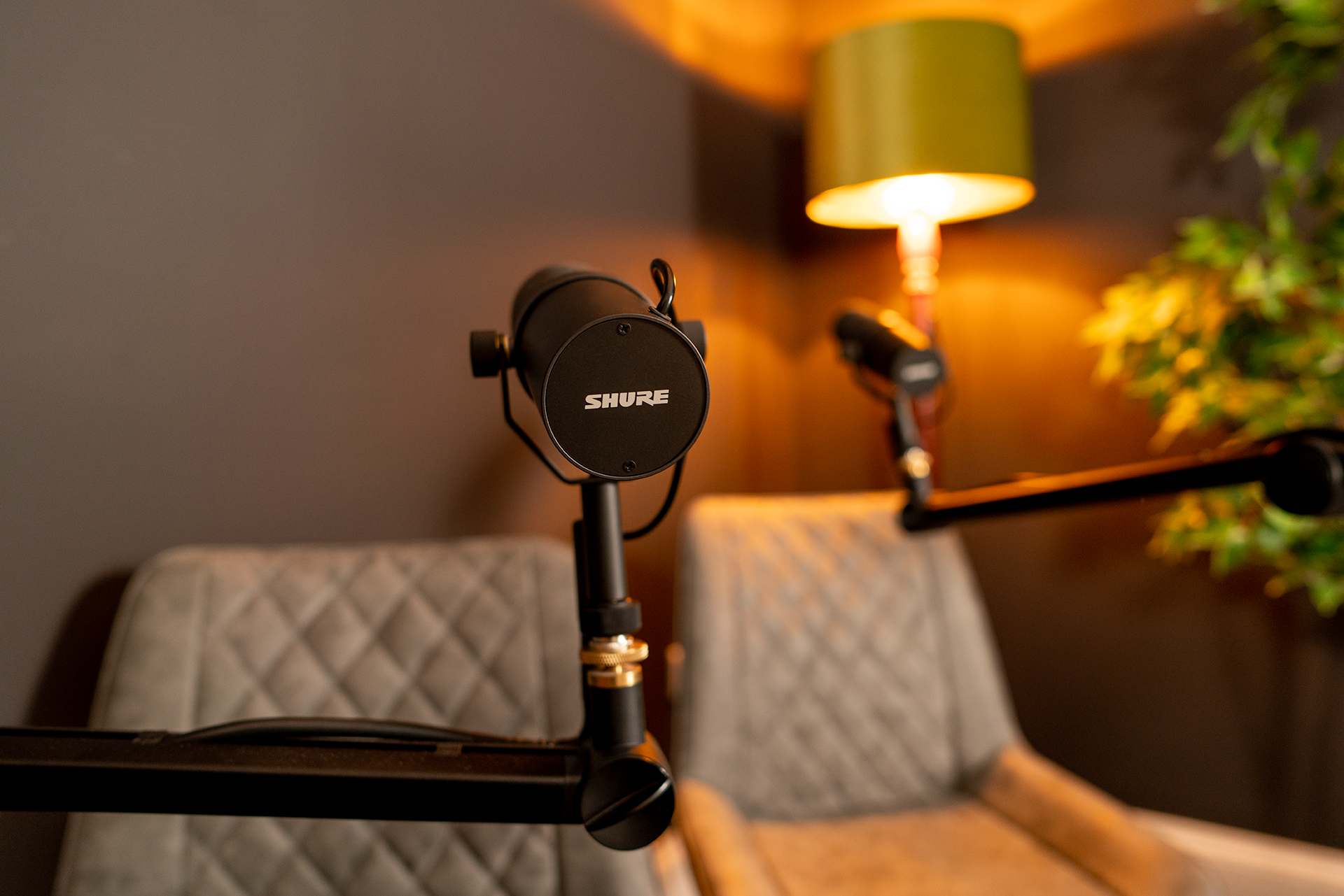 Podcast recording desk and microphones at Material Studios
